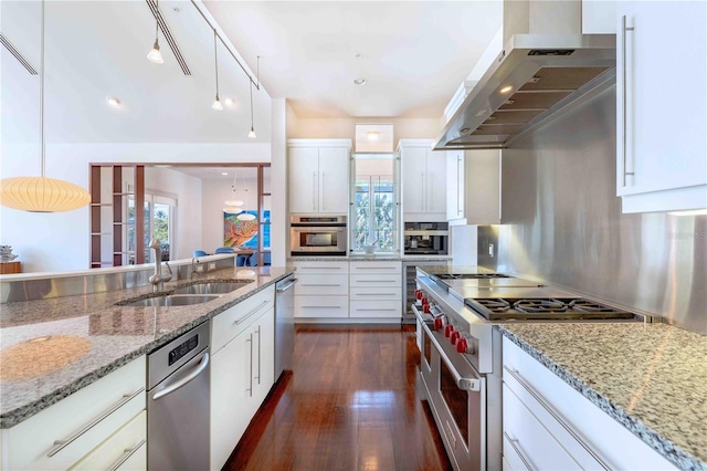 kitchen with ventilation hood, appliances with stainless steel finishes, hanging light fixtures, and white cabinets