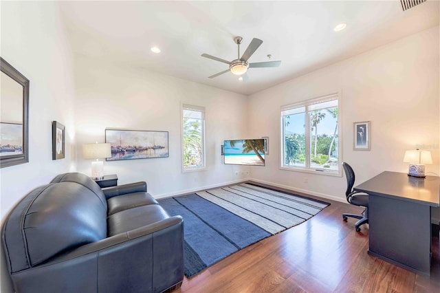 office area with ceiling fan, a healthy amount of sunlight, and dark hardwood / wood-style floors