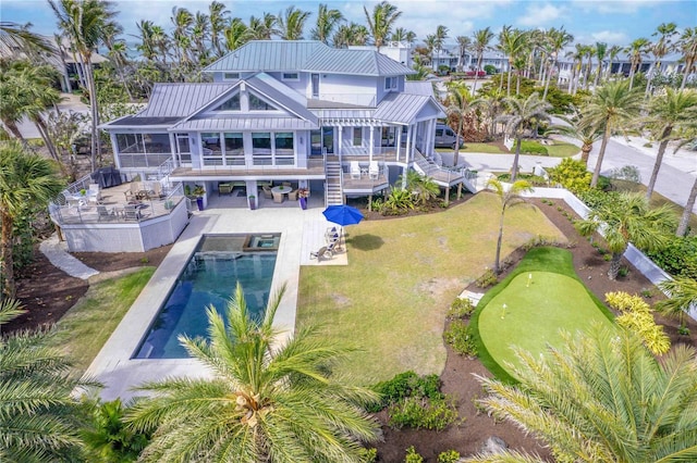 back of property with a balcony, a yard, an outdoor hangout area, and a patio area