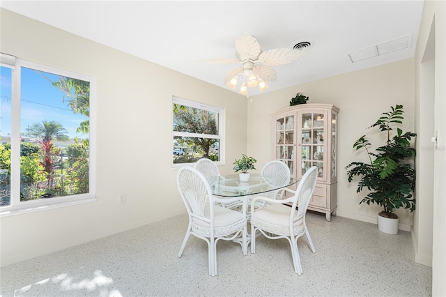 dining area featuring baseboards, a ceiling fan, visible vents, and a healthy amount of sunlight