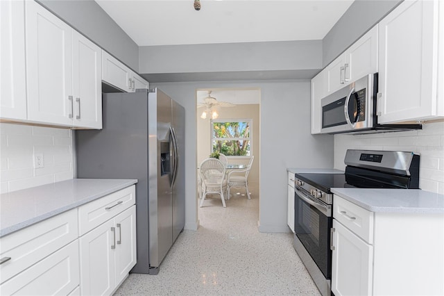 kitchen featuring a ceiling fan, white cabinets, light countertops, appliances with stainless steel finishes, and decorative backsplash