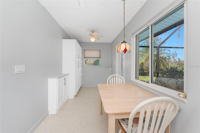 dining area with a ceiling fan, baseboards, and a wealth of natural light