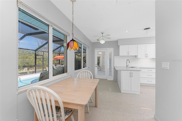 dining space featuring ceiling fan, visible vents, and a sunroom