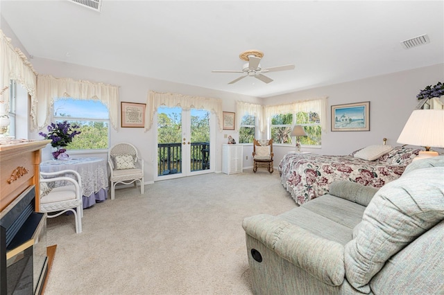 bedroom with light carpet, multiple windows, visible vents, and access to exterior