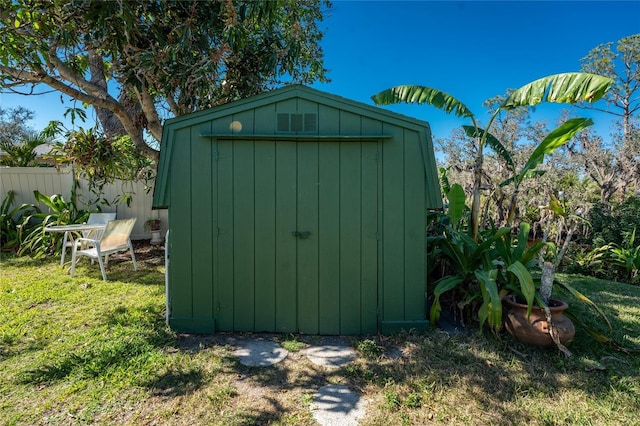 view of shed featuring fence