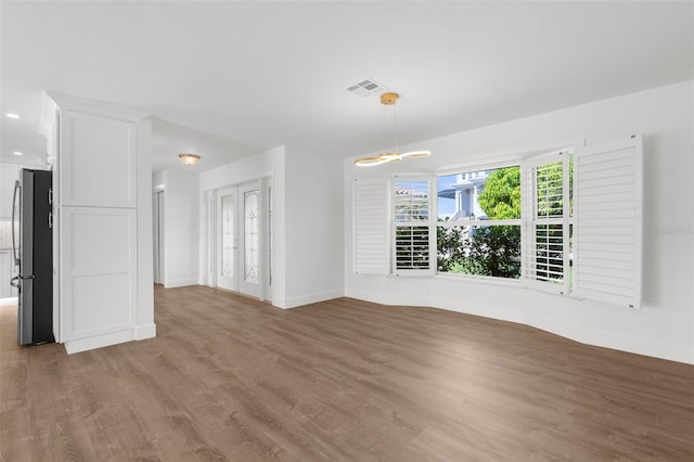 2160 Palm Tree Dr, Punta Gorda, FL 33950 - unfurnished living room with wood finished floors and a chandelier
