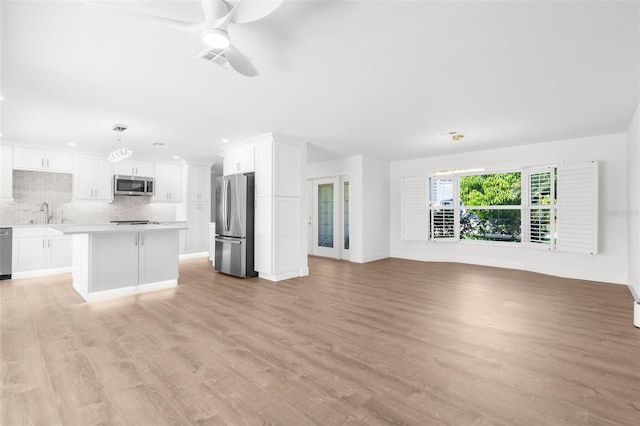 2160 Palm Tree Dr, Punta Gorda, FL 33950 - unfurnished living room with ceiling fan, light wood-style flooring, and recessed lighting