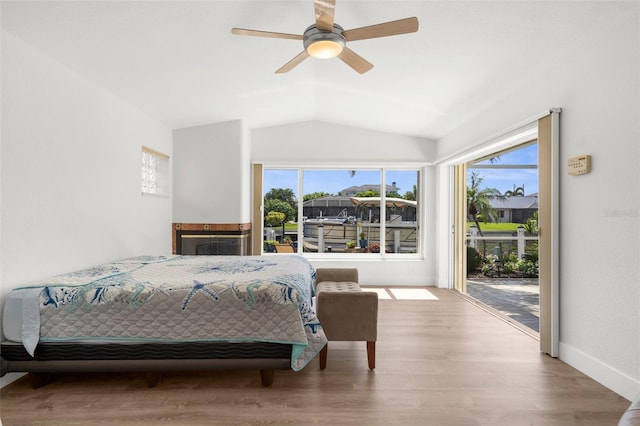 2160 Palm Tree Dr, Punta Gorda, FL 33950 - bedroom with lofted ceiling, access to exterior, wood finished floors, and a ceiling fan