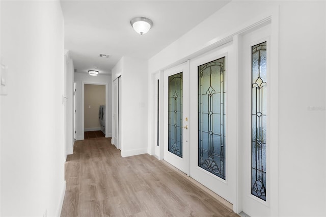 2160 Palm Tree Dr, Punta Gorda, FL 33950 - foyer featuring light wood-type flooring, french doors, and washer / clothes dryer