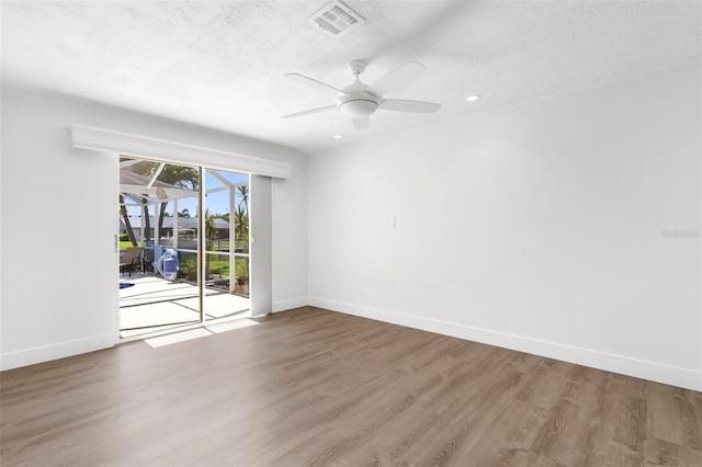 2160 Palm Tree Dr, Punta Gorda, FL 33950 - unfurnished room with a textured ceiling, wood finished floors, a ceiling fan, and recessed lighting