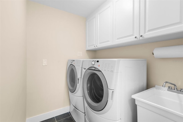 2160 Palm Tree Dr, Punta Gorda, FL 33950 - laundry room featuring separate washer and dryer, cabinet space, and dark tile patterned floors