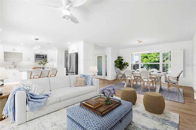 2160 Palm Tree Dr, Punta Gorda, FL 33950 - living area featuring a ceiling fan, light wood-type flooring, and recessed lighting