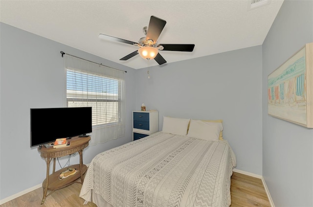 bedroom featuring light wood-type flooring and ceiling fan