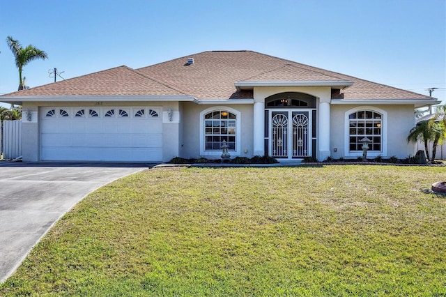 ranch-style home featuring a garage and a front lawn