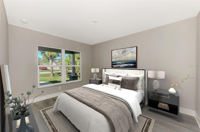 bedroom with light wood-style flooring and baseboards