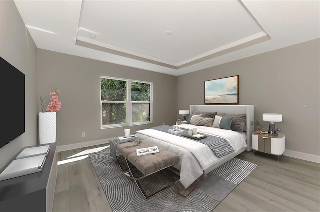 bedroom featuring a tray ceiling, baseboards, and wood finished floors