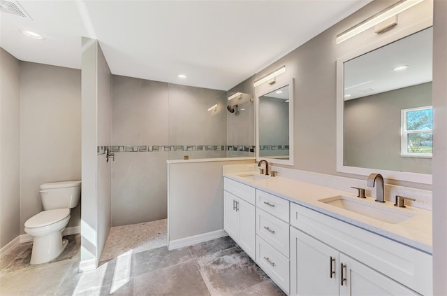 full bathroom featuring visible vents, a sink, toilet, and double vanity