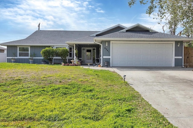 single story home featuring a front lawn, concrete driveway, roof with shingles, and an attached garage