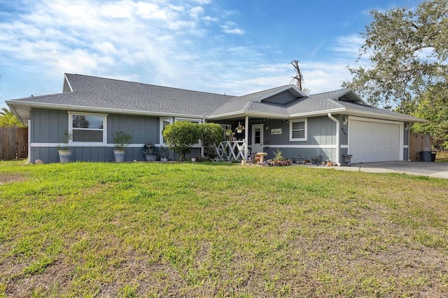 view of front of house featuring a garage, concrete driveway, and a front yard