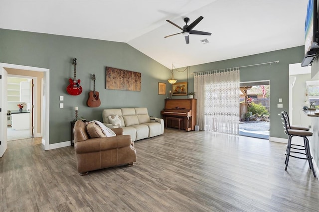 living room with lofted ceiling, visible vents, baseboards, and wood finished floors