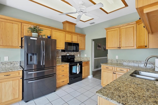 kitchen featuring visible vents, a sink, black appliances, backsplash, and light tile patterned flooring