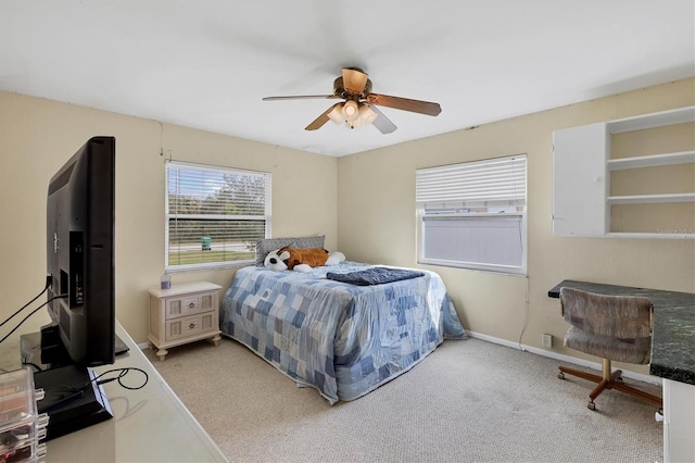 bedroom featuring light colored carpet, ceiling fan, and baseboards