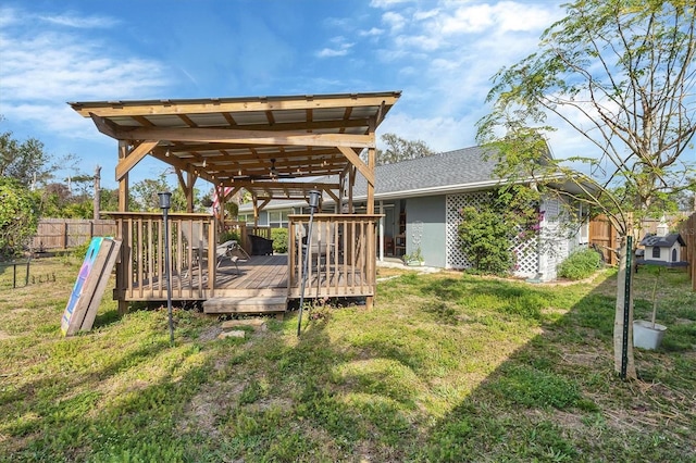 view of yard featuring fence and a wooden deck