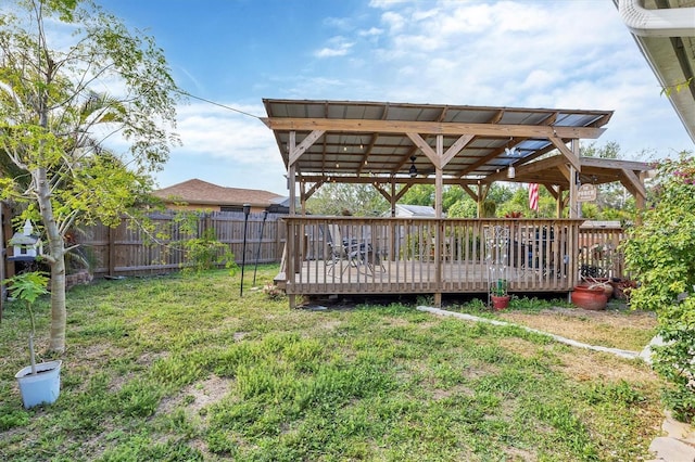 view of yard featuring a fenced backyard, a deck, and a pergola