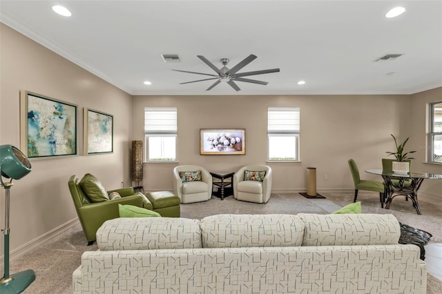 living room with light carpet, crown molding, and a wealth of natural light