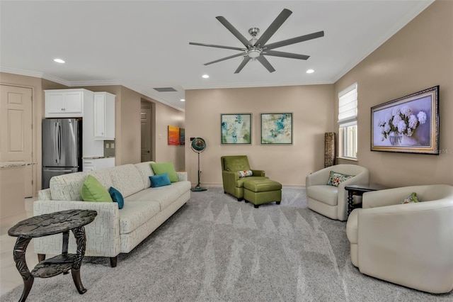 carpeted living room featuring ornamental molding and ceiling fan