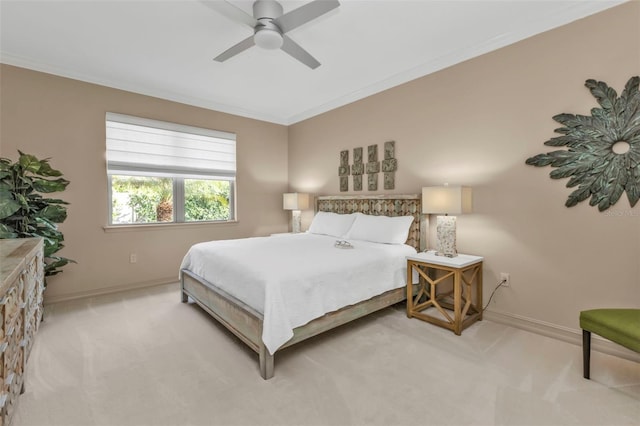 carpeted bedroom featuring crown molding and ceiling fan