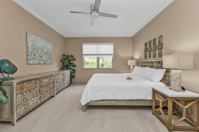 carpeted bedroom featuring ceiling fan and ornamental molding