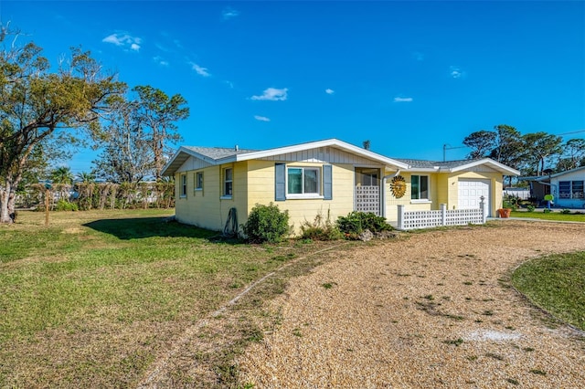 ranch-style home with a garage and a front yard