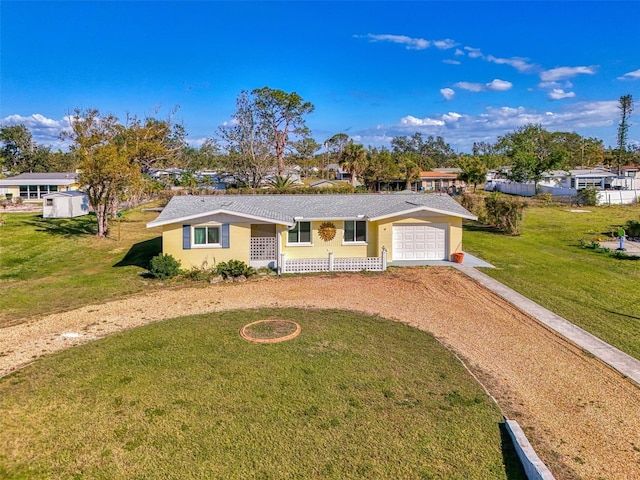 ranch-style home with a front yard and a garage