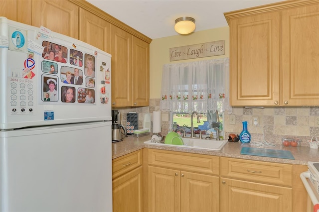 kitchen featuring white fridge, sink, backsplash, stove, and light brown cabinets