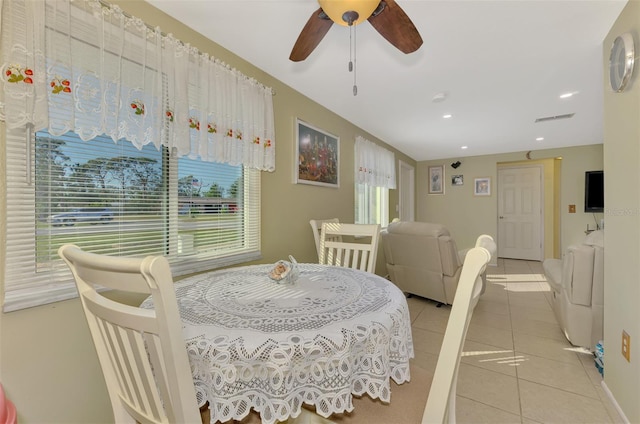 tiled dining space featuring ceiling fan