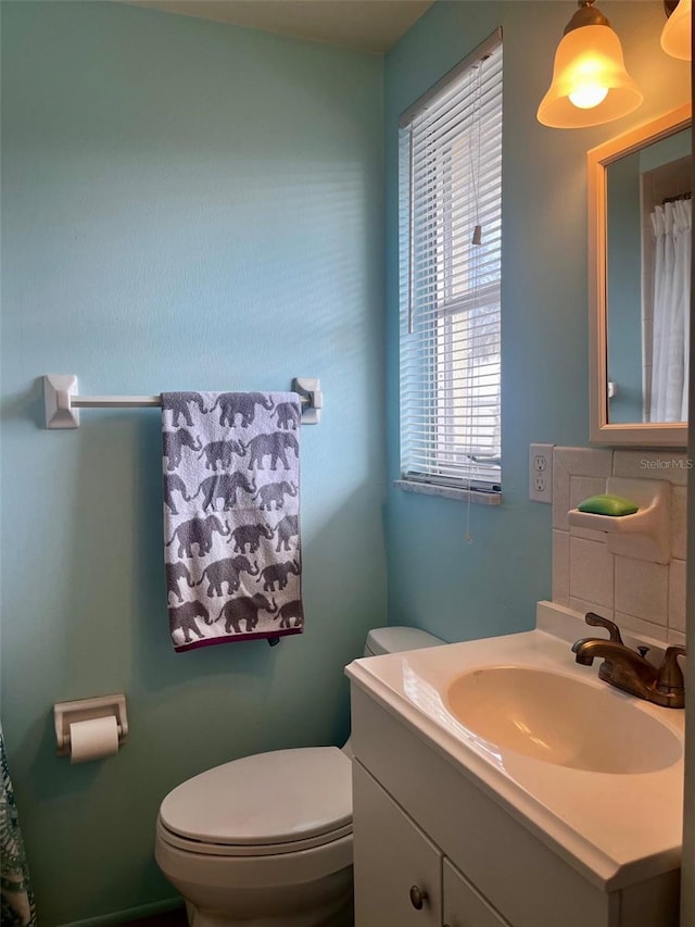 bathroom featuring toilet and vanity