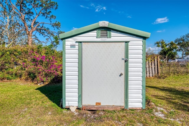 view of outbuilding with a lawn