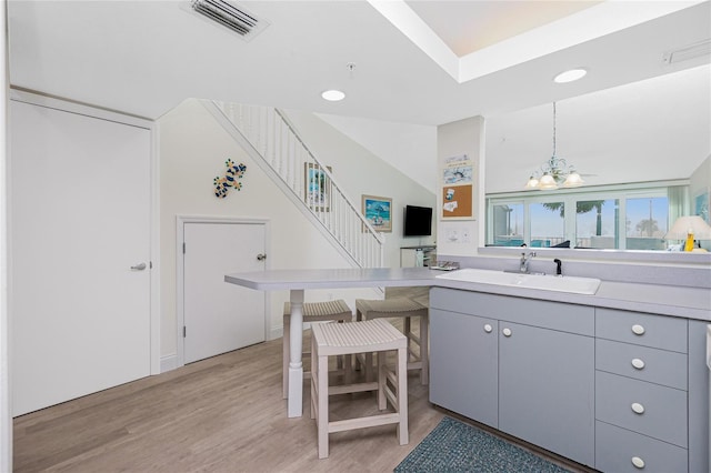 2255 N Beach Rd Unit 13, Englewood, FL 34223 - kitchen with light wood-type flooring, pendant lighting, light countertops, and a sink