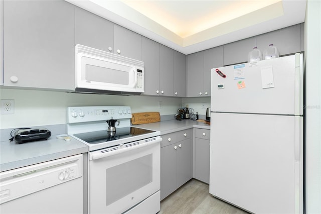 2255 N Beach Rd Unit 13, Englewood, FL 34223 - kitchen with light countertops, gray cabinets, light wood finished floors, and white appliances