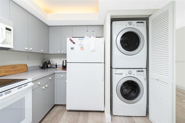 2255 N Beach Rd Unit 13, Englewood, FL 34223 - laundry area featuring light wood-style flooring, stacked washer / drying machine, and laundry area