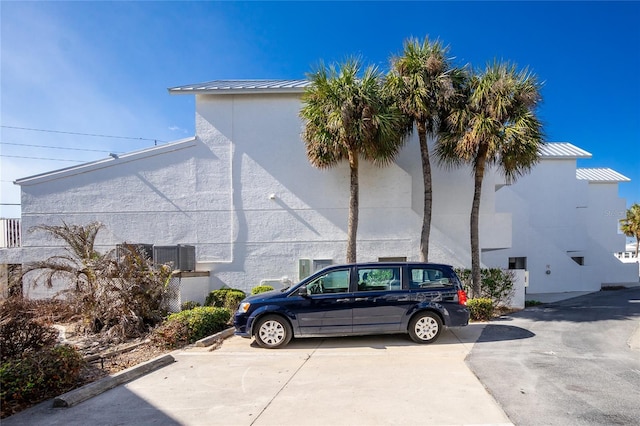 2255 N Beach Rd Unit 13, Englewood, FL 34223 - view of side of home with a standing seam roof, stucco siding, and metal roof