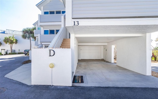 2255 N Beach Rd Unit 13, Englewood, FL 34223 - exterior space with stucco siding, concrete driveway, and a garage