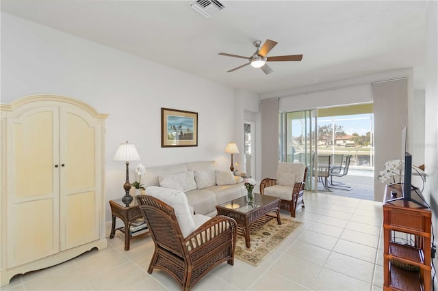 living room featuring light tile patterned floors, visible vents, and ceiling fan