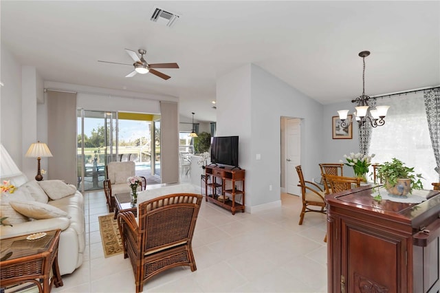 living room with light tile patterned floors, visible vents, baseboards, lofted ceiling, and ceiling fan with notable chandelier