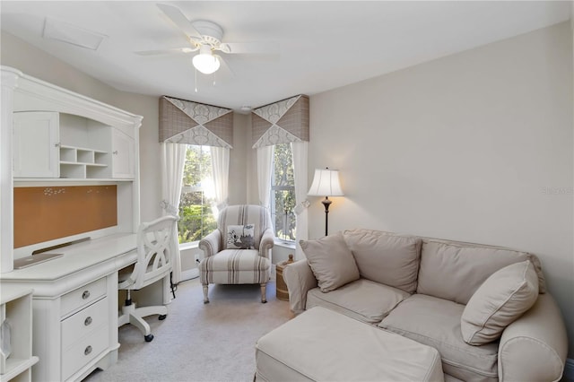 office space with light colored carpet and a ceiling fan