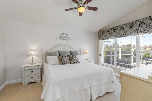 bedroom featuring lofted ceiling, light colored carpet, baseboards, and ceiling fan