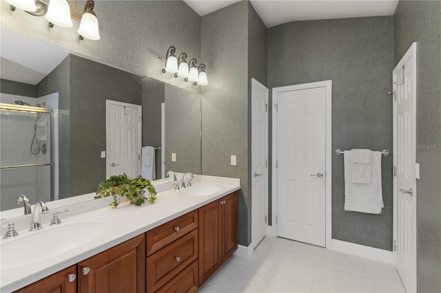 bathroom featuring a sink, double vanity, a stall shower, and tile patterned floors