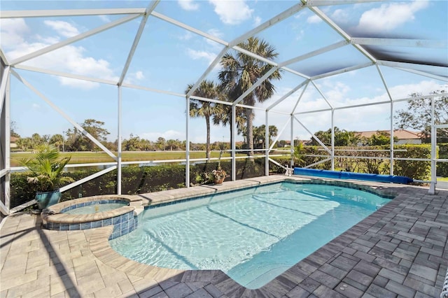 view of pool featuring a patio, a pool with connected hot tub, and a lanai