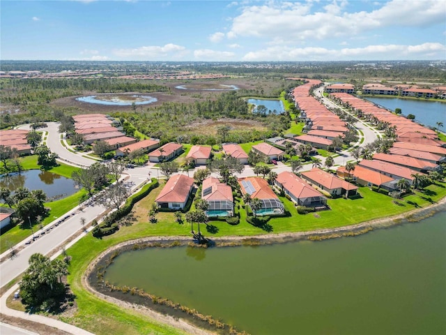 drone / aerial view featuring a water view and a residential view